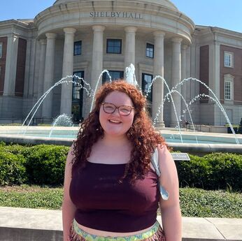 Molly Sullivan standing in front of the Shelby fountain.