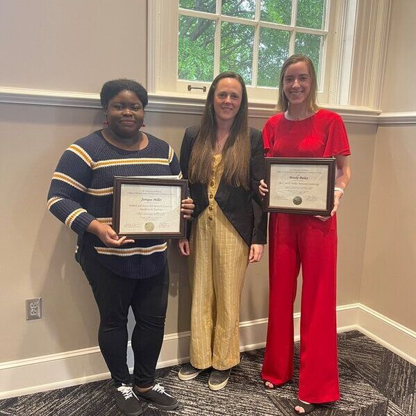 Dr. Higgins with Janique and Brooke, who are holding their awards.